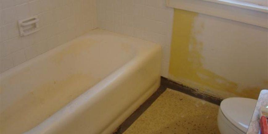 Bathtub before reglazing — stained and worn